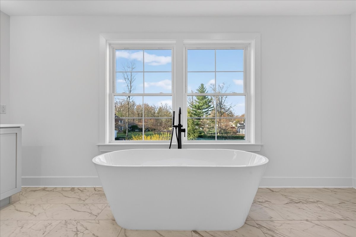 Primary bath with soaking tub between windows